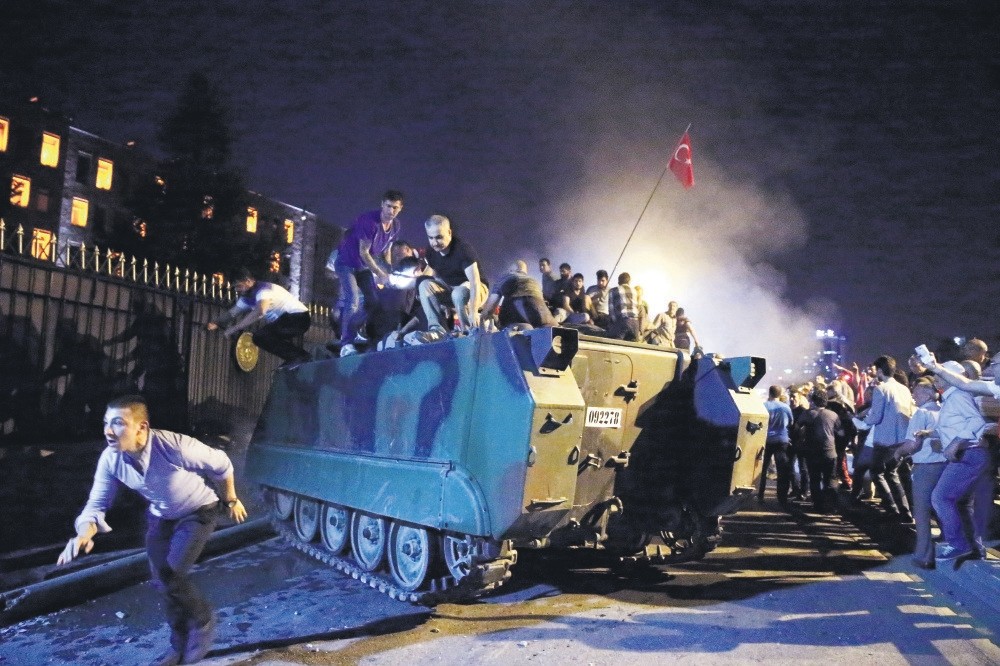 An anti-coup crowd surround and capture a tank hijacked by putschists outside the main military headquarters in Ankara. Putschists had captured several strategic locations in the capital, including the Tu00fcrk Telekom building, on July 15, 2016.
