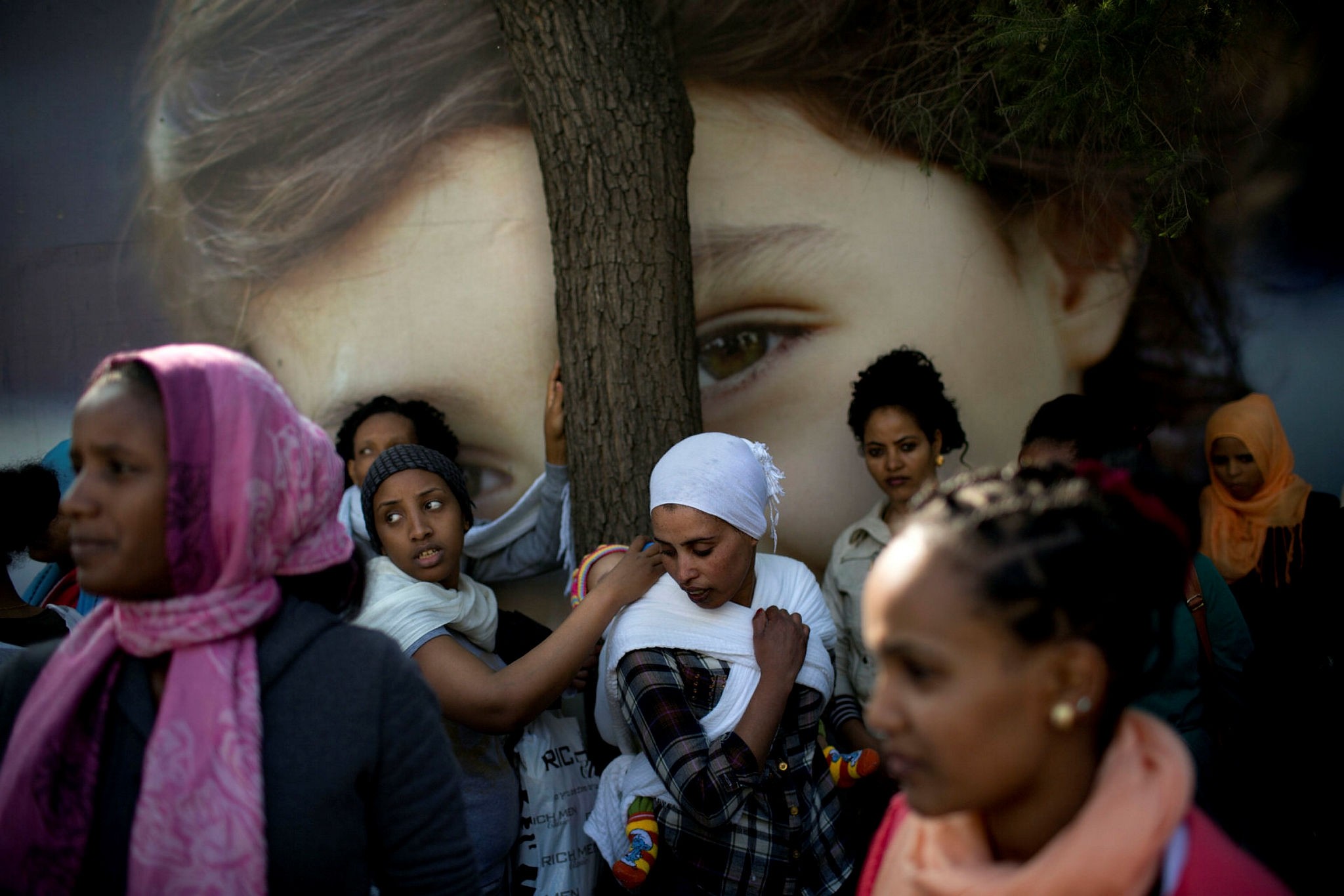 In this  Jan. 15, 2014, file photo, African female and child migrants protest in front of the UNHCR office demanding asylum and work rights from the Israeli government in Tel Aviv, Israel. (AP Photo)