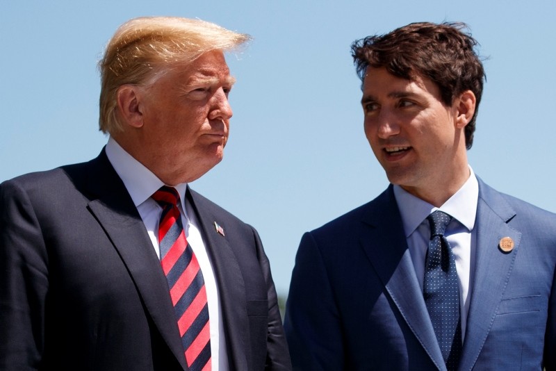 U.S. President Donald Trump talks with Canadian Prime Minister Justin Trudeau during a G-7 Summit welcome ceremony, Friday, June 8, 2018, in Charlevoix, Canada. (AP Photo)