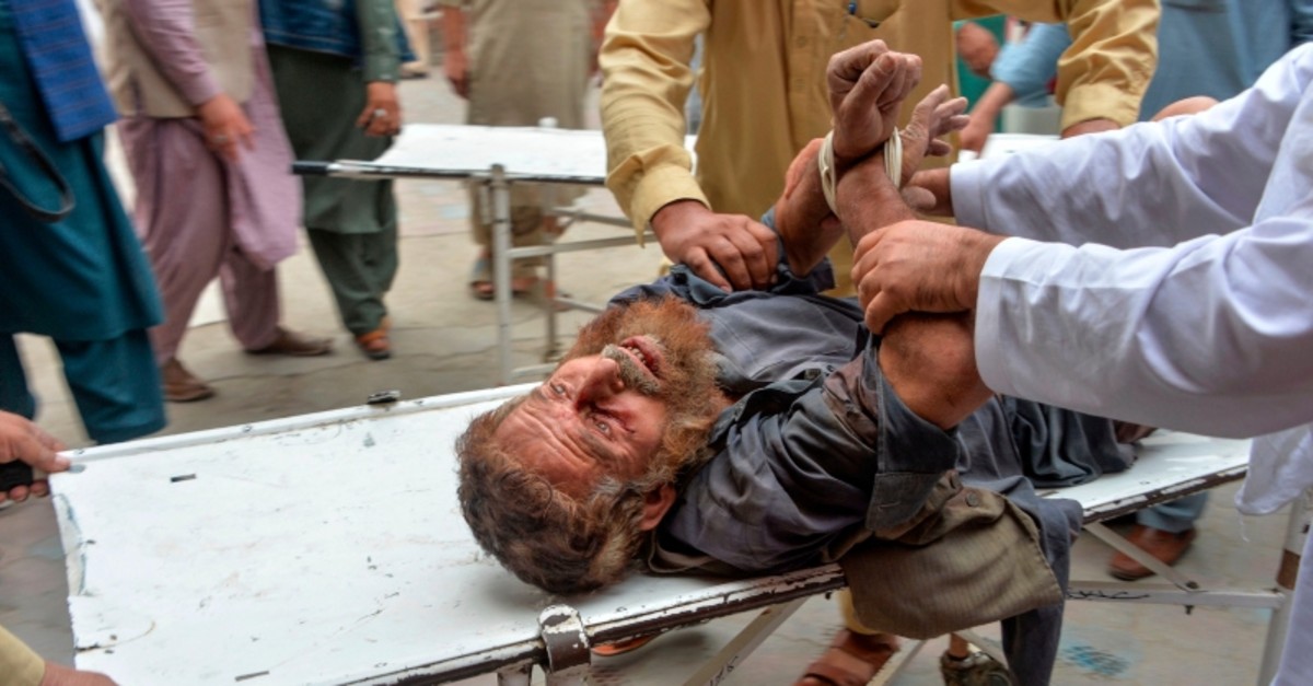 Volunteers carry an injured man on a stretcher to a hospital, following a bomb blast in Haska Mina district of Nangarhar Province on October 18, 2019. (AFP Photo)