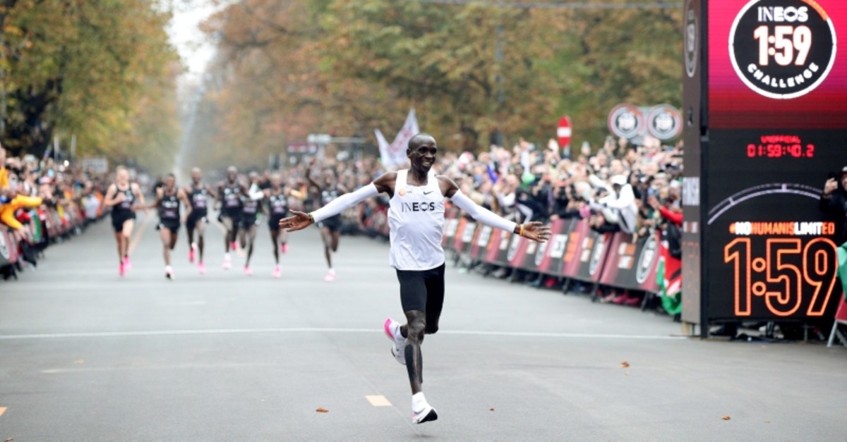 Eliud Kipchoge, the marathon world record holder, wearing Nike Vaporfly shoes, crosses the finish line during his attempt to run a marathon in under two hours, Vienna, Oct. 12, 2019. (Reuters Photo)