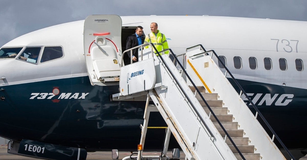 In this April 3, 2019, image courtesy of Boeing, Dennis Muilenburg (front), CEO of Boeing, exits a 737 MAX 7 after joining test pilot for a flight demo of updated MCAS software, in Seattle. (AFP Photo)