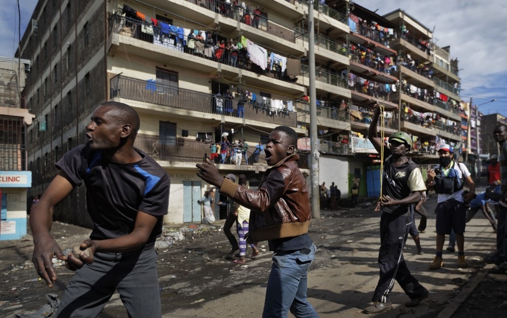 Opposition protesters throw rocks at riot police by hand and with slingshots during clashes with police in Nairobi, Oct. 26.