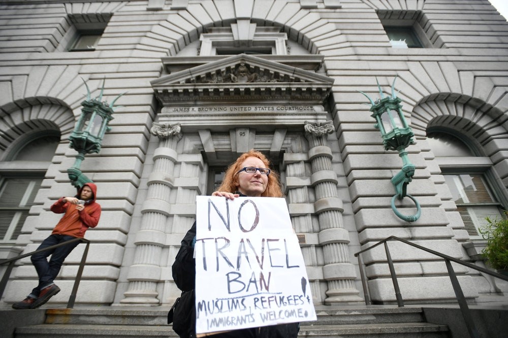 Author Beth Kohn protests against the travel ban, outside the 9th U.S. Circuit Court of Appeals courthouse in San Francisco.
