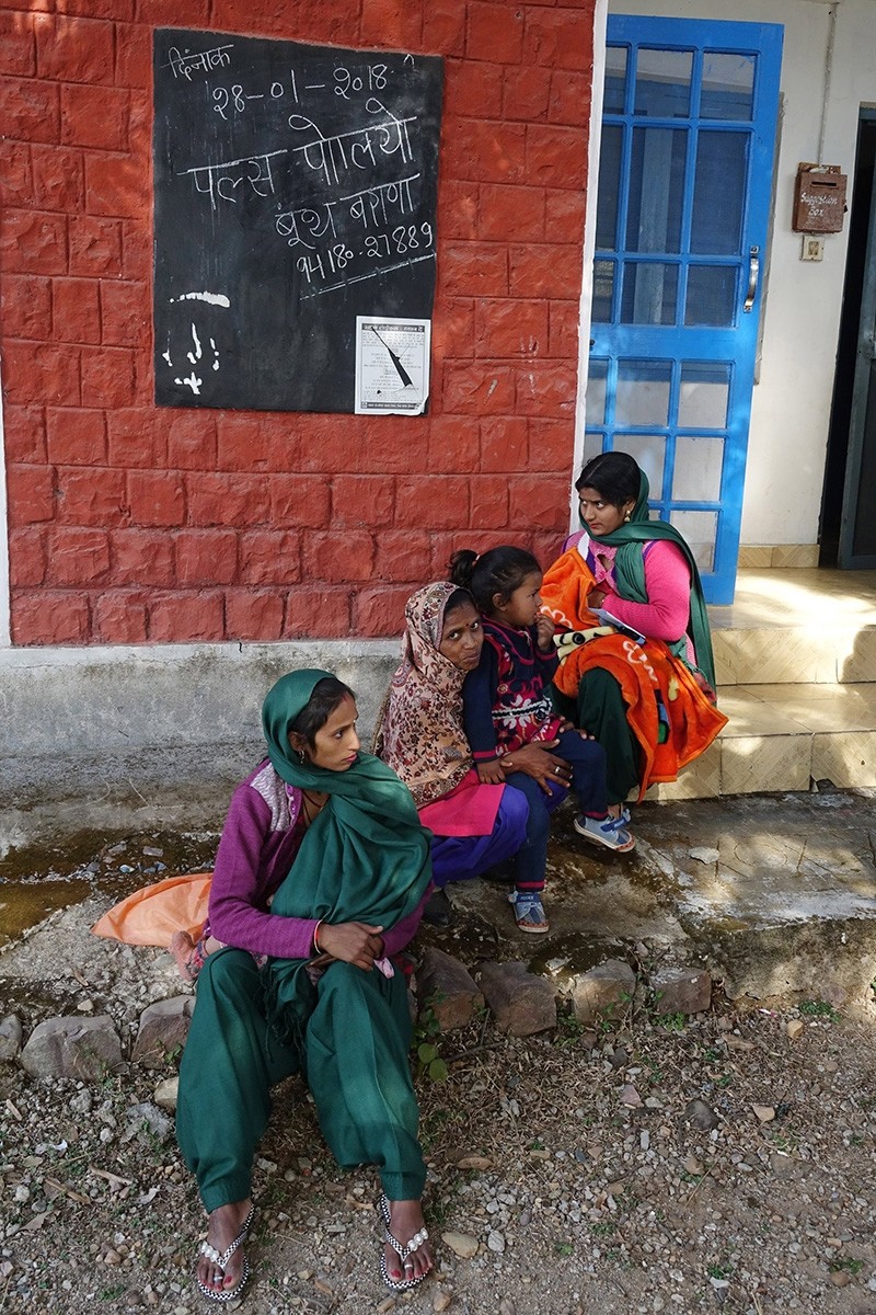 Indian women wait as they visit to get children administered for pulse polio drops at a booth in Barana village, some 40 km from Dharamsala, India, Jan. 28 2018. (EPA Photo)