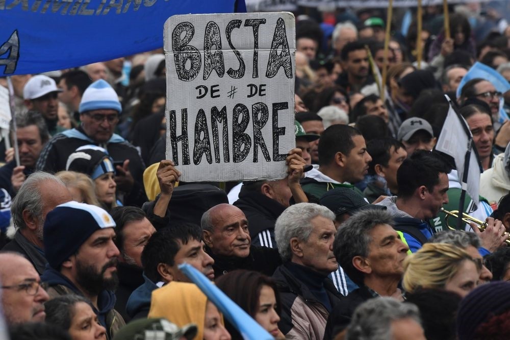 A protester holds a placard reading ,No More Hunger, during a demonstration against the government of Argentine President Mauricio Macri.