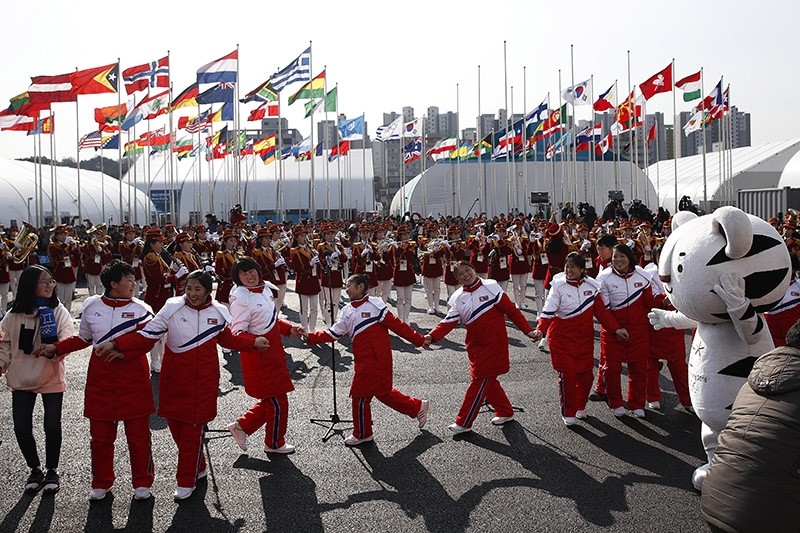 In this Feb. 8, 2018 photo, North Korean athletes dance as members of the county's cheering group perform during a welcome ceremony at the Olympic Village ahead of the 2018 Winter Olympics in Gangneung, South Korea. (AP Photo)