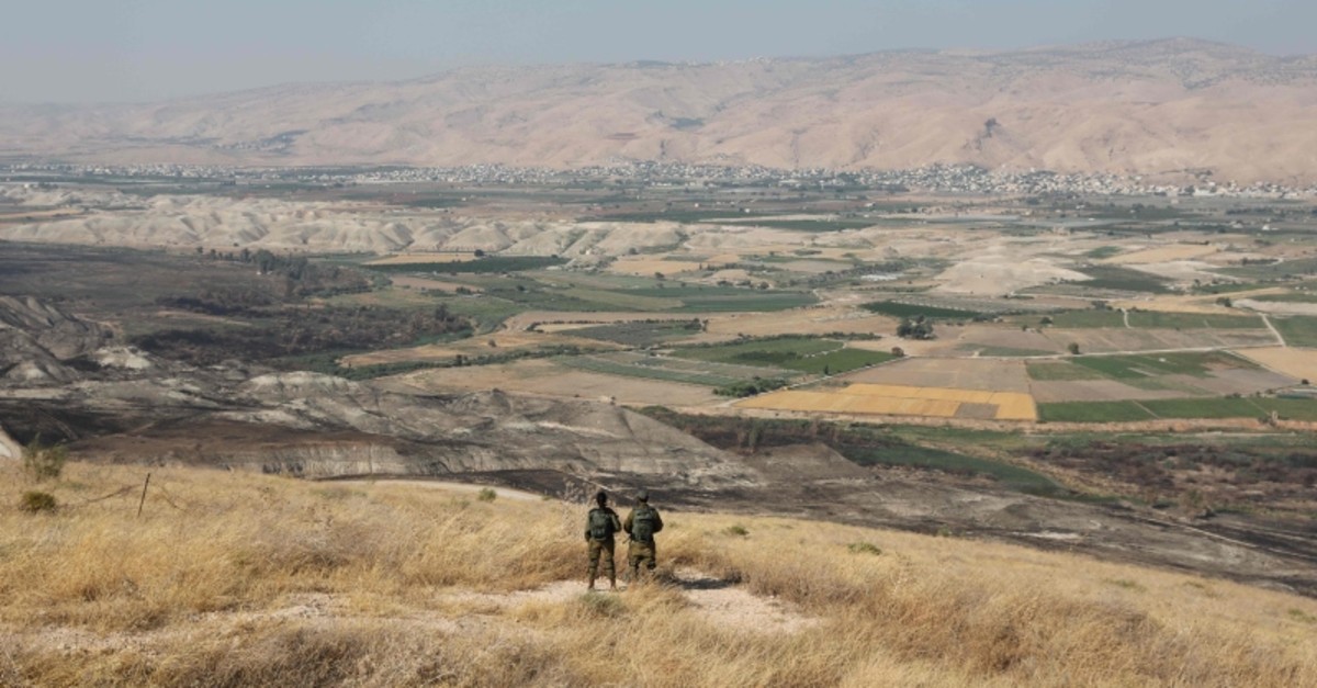 In this file photo taken on June 23, 2019 Israeli soldiers stand guard in an old army outpost overlooking the Jordan Valley  between the Israeli city of Beit Shean and the West Bank city of Jericho (AFP Photo)