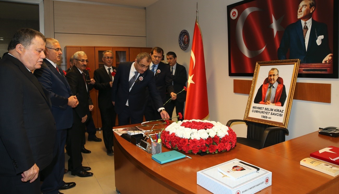 Colleagues place flowers on the desk of Mehmet Selim Kiraz on the anniversary of his death in 2017.