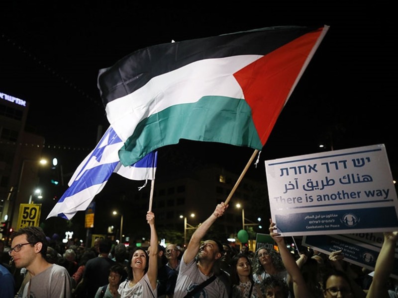 Israeli demonstrators waving Israeli and Palestinian flags during a protest rally supporting the two states solution between Israel and the Palestinians, in Rabin square (EPA Photo)