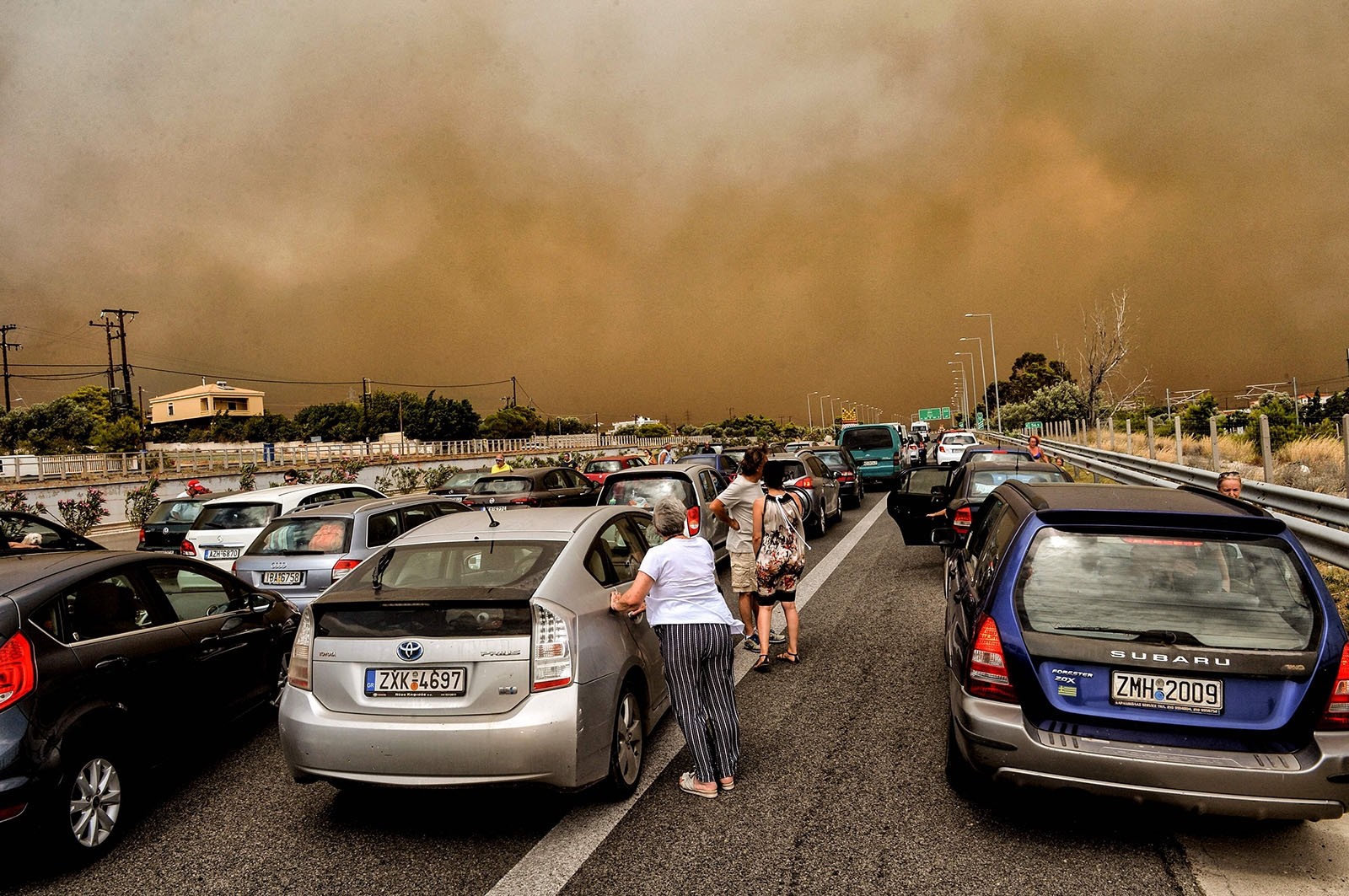 Cars are blocked at the closed National Road during a wildfire in Kineta, near Athens, on July 23, 2018.