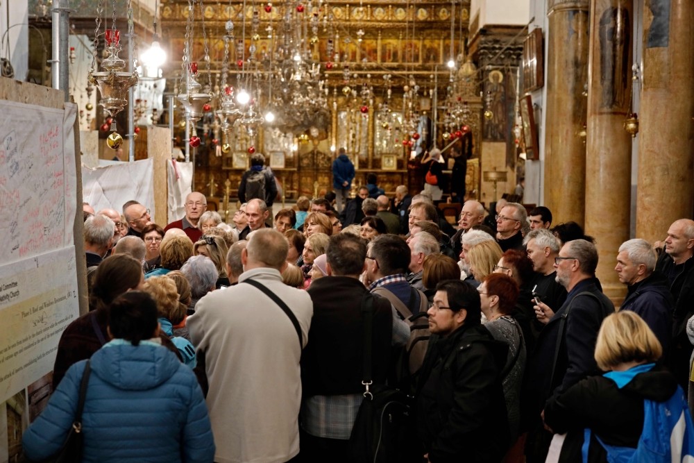 A group of tourists and pilgrims visit the Church of the Nativity, the place where Jesus is said to have been born, in the occupied biblical West Bank town of Bethlehem.