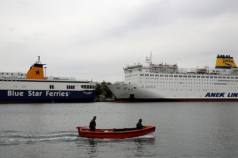Two men sail in a wooden boat next to moored ferries during a 48-hour nationwide strike of Greek seamen at the Port of Piraeus, near Athens, Greece, May 16, 2017. (Reuters Photo)