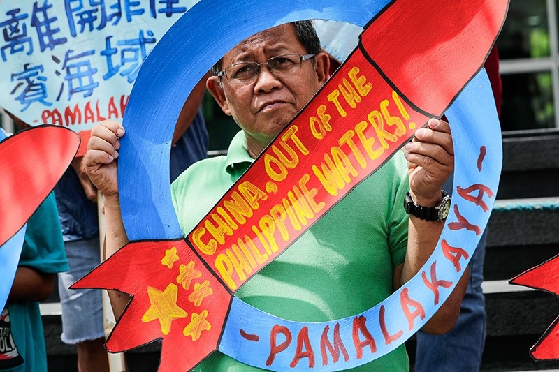 A man holds a missile shaped placard during a protest at the Chinese Consulate in Makati, south of Manila, Philippines, May 18, 2018. (EPA Photo)