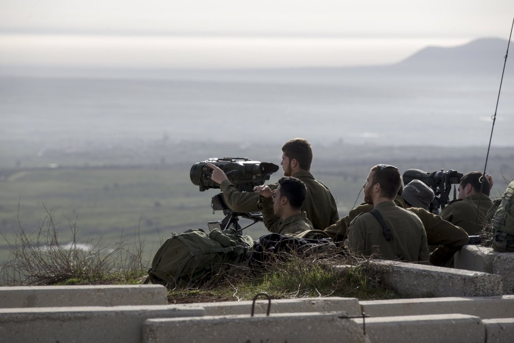 Israeli soldiers takes positions next to the Israeli-Syrian border, Feb. 10.