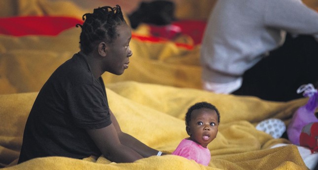 Migrants rest at a makeshift emergency center at Barbate's municipal sports center in the south of Spain, June 29.