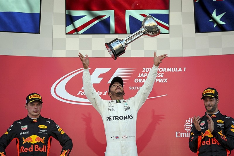 British driver Lewis Hamilton (C) of Mercedes AMG GP celebrates after winning the Japanese Grand Prix next to 2nd Dutch Max Verstappen (L) and 3rd Australian Daniel Ricciardo of Red Bull Racing at the Suzuka Circuit, Japan, Oct. 8, 2017. (EPA Photo)