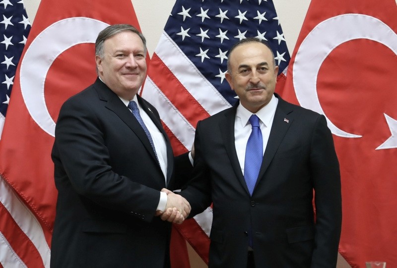 FM u00c7avuu015fou011flu shakes hands with US Secretary of State Pompeo following a NATO meeting in Brussels (AA File Photo) 