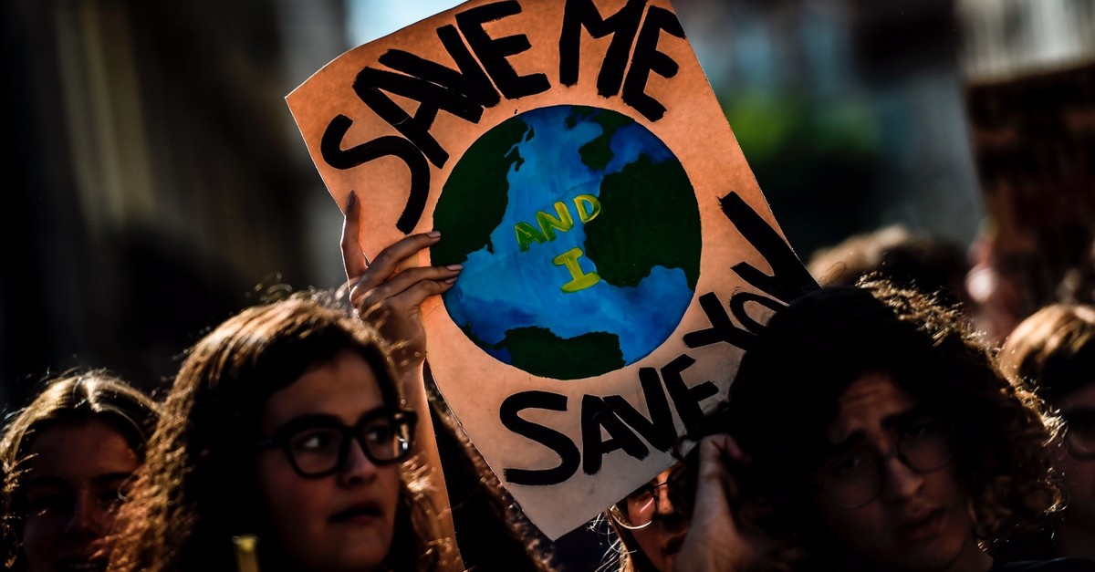 Demonstrators take part in a global youth climate action strike in Lisbon, Sept. 27, 2019.
