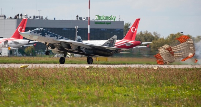 Russian Air Force Sukhoi Su-57 fighter jet lands after performing as Turkish president's delegation planes are parked in the background during the MAKS-2019 International Aviation and Space Show in Zhukovsky, Russia, Aug. 27, 2019. (AP Photo)