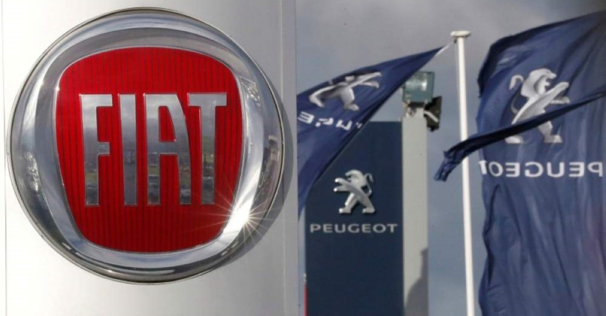 The logos of car manufacturers Fiat and Peugeot are seen in front of dealerships of the companies in Saint-Nazaire, France, Nov. 8, 2019. (REUTERS Photo)