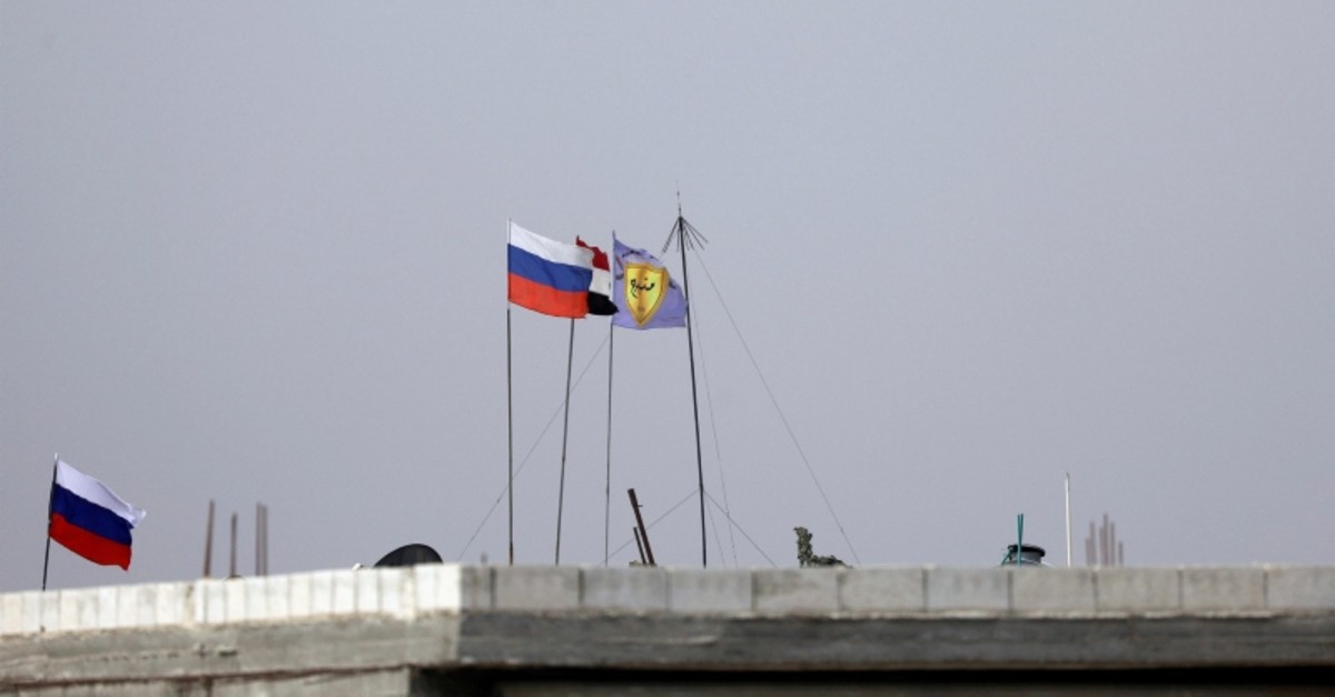 Russian, Syrian and Manbij military council flags flutter near Manbij, Syria October 15, 2019. (Reuters Photo)