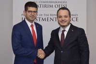 Former head of the  presidential investment office Arda Ermut (right) and new chair (left). (DHA Photo)