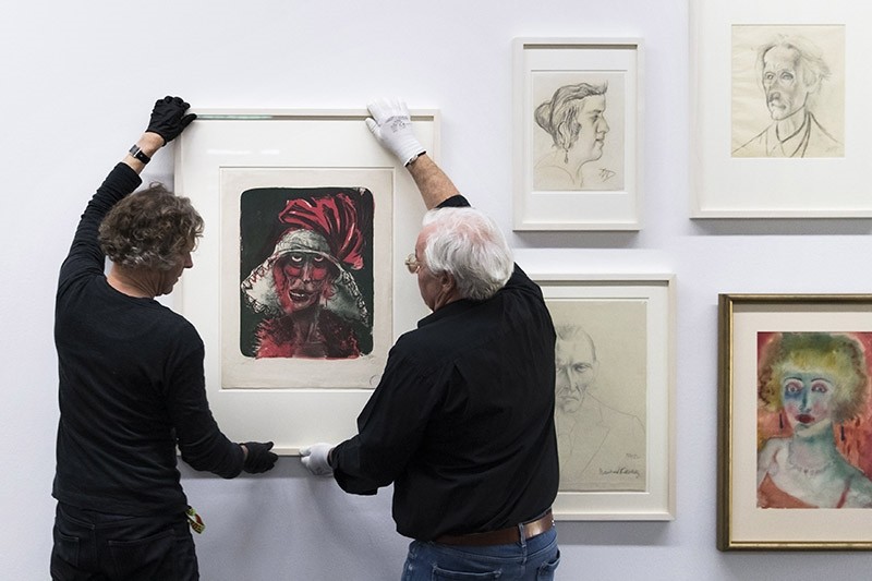 Museum technicians hang the painting ,Leonie, of German painter Otto Dix, before the opening of the exhibition 'Gurlitt: Status Report. Degenerate Art - Confiscated and Sold', in the Kunstmuseum in Bern, Switzerland, October 30 2017. (EPA Photo)