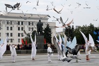 People take part in Victory Day celebrations to mark the defeat of Nazi Germany in World War II, as pigeons fly above in the rebel-controlled city of Luhansk, Ukraine, May 9, 2019.