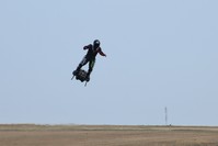 Zapata CEO Franky Zapata flies over fields on his jet-powered hoverboard or ,Flyboard, during a test flight in Saint-Inglevert, northern France, on July 24, 2019 (AFP Photo)