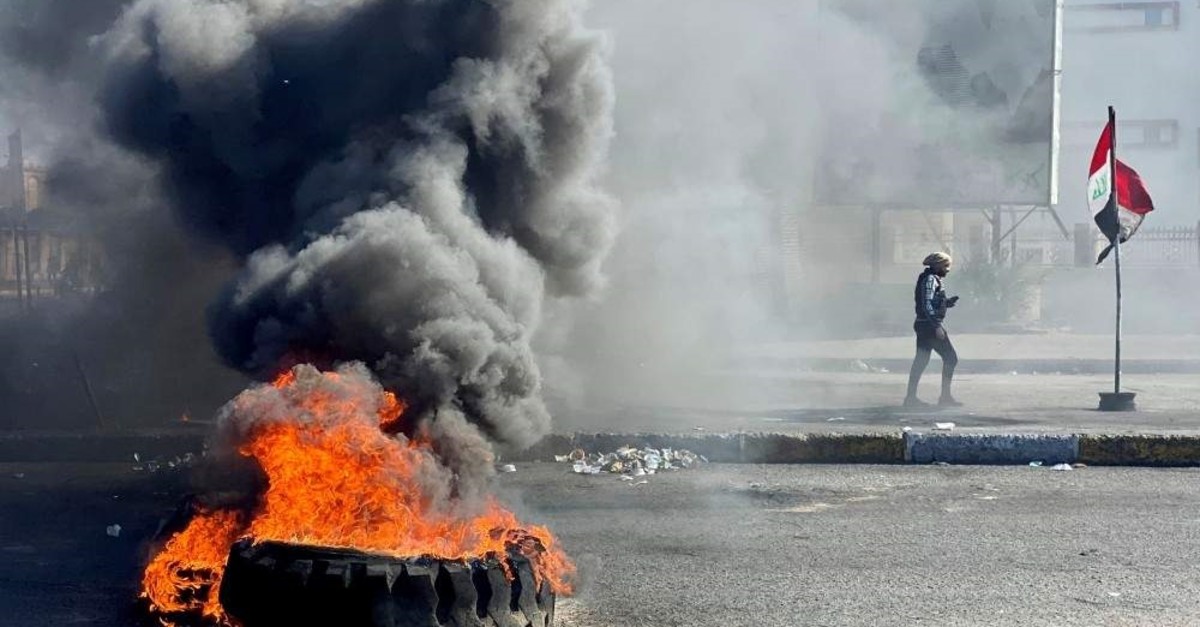 An Iraqi demonstrator walks past burning tires as they block a road during an anti-government protest, Nassiriya, Jan. 27. (REUTERS Photo)