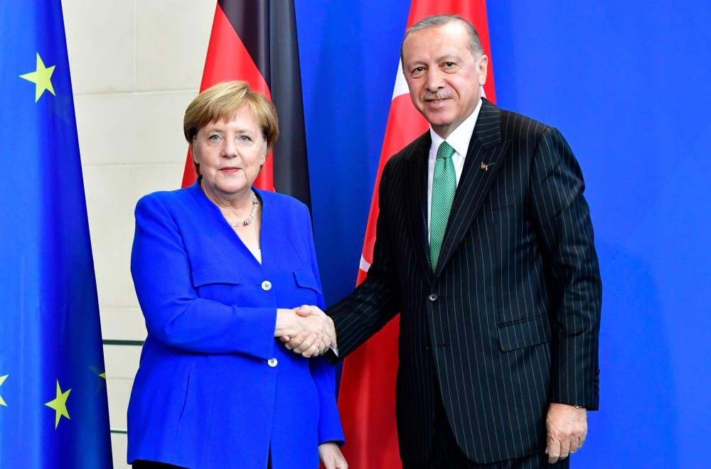 German Chancellor Angela Merkel and President Recep Tayyip Erdou011fan shake hands after a joint press conference on Sept. 28 at the chancellery in Berlin.