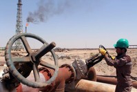 A worker checks the valve of an oil pipe at al-Sheiba oil refinery in the southern Iraq city of Basra, Iraq, April 17, 2016. (Reuters Photo)