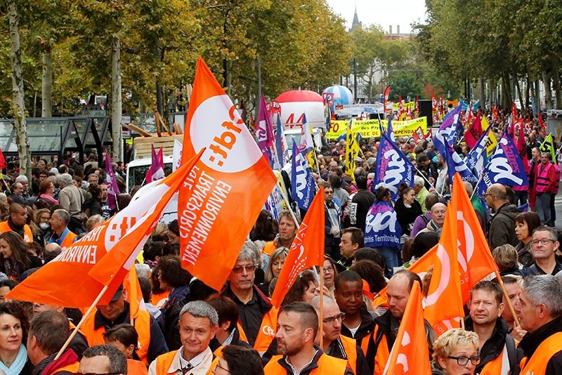 Public sector workers hold flags of the French Democratic Confederation of Labour union (CFDT) during a demonstration as part of a nationwide strike against French government reforms in Nantes, France, October 10, 2017. (Reuters Photo)