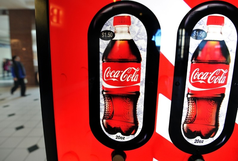 In this file photo taken on February 15, 2011, a woman walks past a Coca Cola vending machine at a shopping mall in Arlington, Virgina. (AFP Photo)