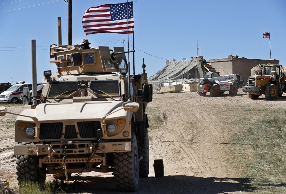 A U.S. soldier (L) sits in an armored vehicle in Manbij, April 4, 2018.