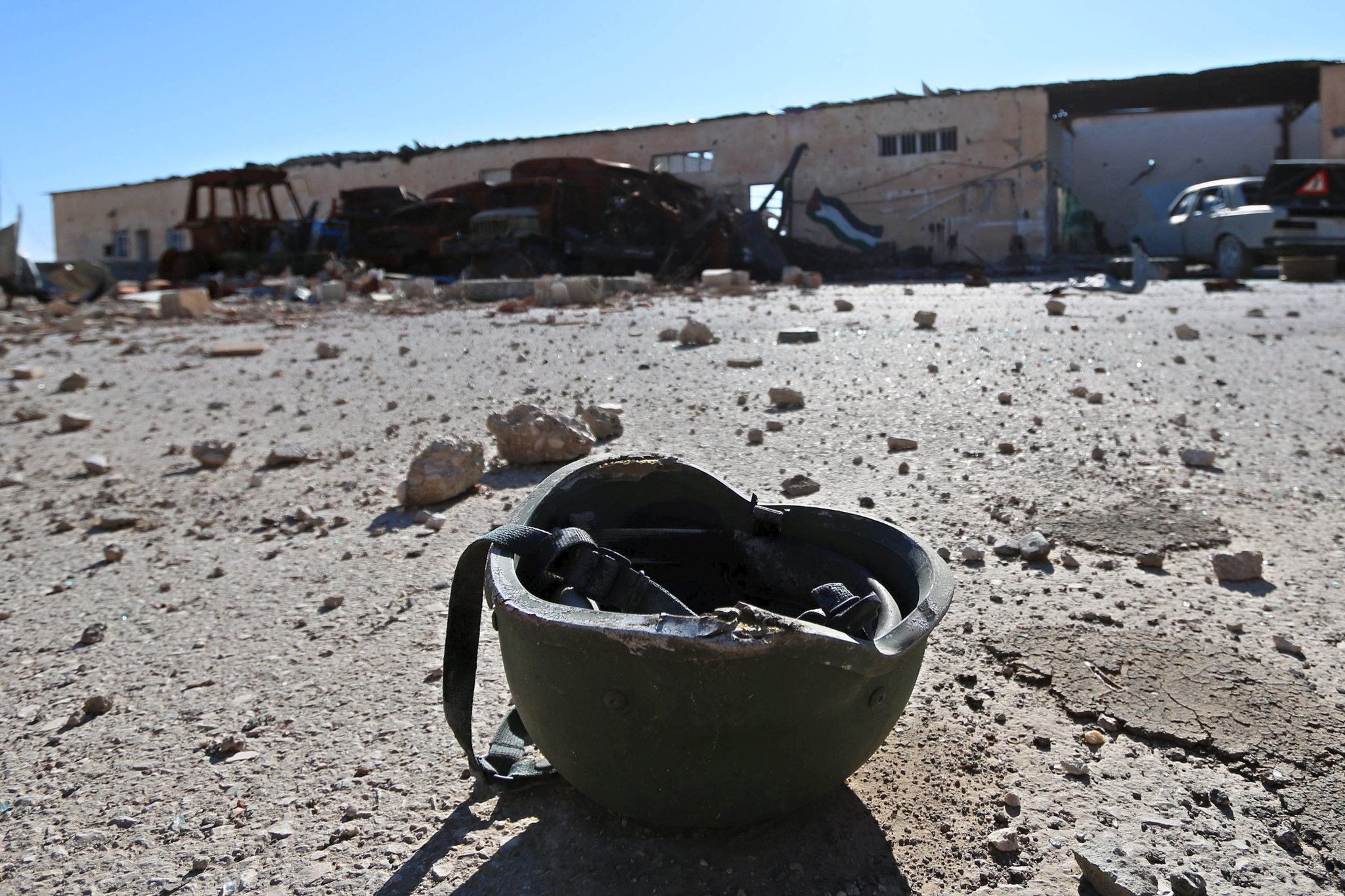 A helmet belonging to a Daesh militant is seen on the ground at the 121 regiment base in the town of al-Melabiyyah after it was retaken from the terror group, south of Hasaka city, Syria, Nov. 24, 2015. 