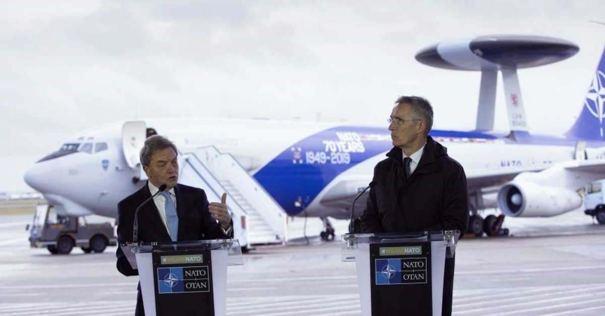 NATO Secretary General, Jens Stoltenberg, right, and the President of Boeing International, Sir Michael Arthur, speak during a media conference at Melsbroek military airport in Melsbroek, Belgium, Nov. 27, 2019. (AP Photo)