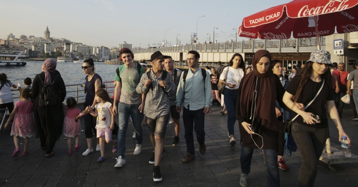 People walk near the Golden Horn in Istanbul ahead of the June 23 rerun of the Istanbul mayoral elections, June 20, 2019. 