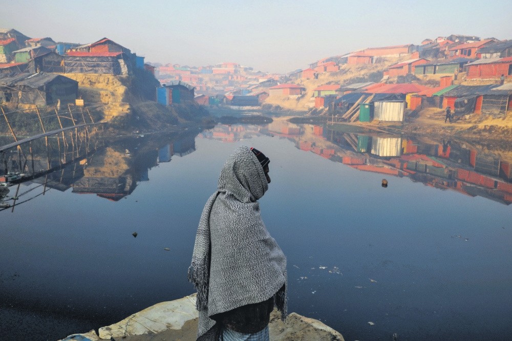 A Rohingya refugee stands next to a pond at the Balukhali refugee camp near Cox's Bazar, Bangladesh, Dec. 26, 2017.