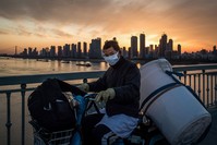 This photo taken on Feb. 17, 2020, shows a man wearing a protective face mask riding a scooter in Wuhan in China's central Hubei province. (AFP Photo)