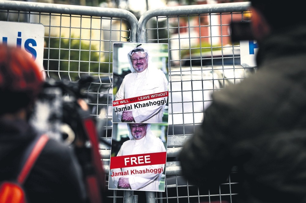 Pictures of slain Saudi journalist Jamal Khashoggi are seen on a fence set up by police in front of the Saudi Consulate in Istanbul during a demonstration, Oct. 14, 2018. 