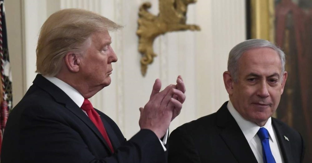 The U.S. President Donald Trump listens as Israeli Prime Minister Benjamin Netanyahu speaks during an event in the East Room of the White House, Washington, D.C., Jan. 28, 2020. (AP Photo)