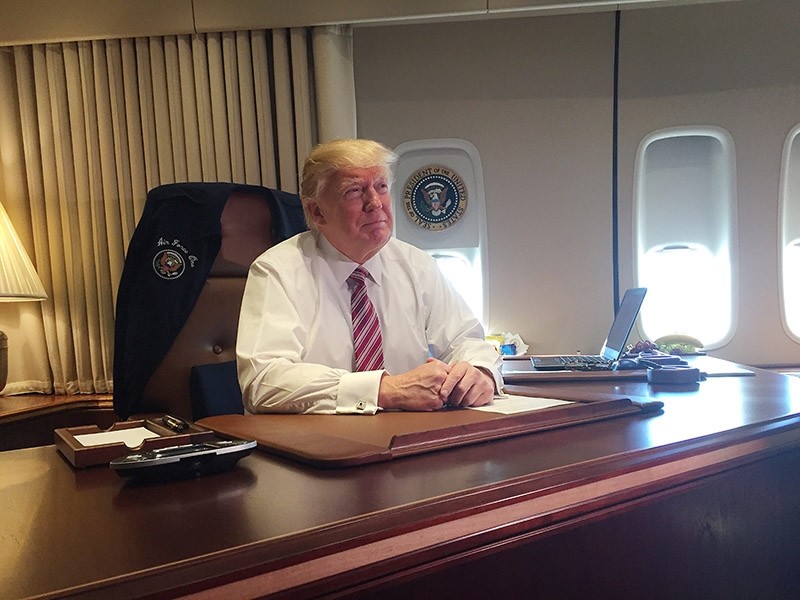US President Donald J. Trump sits at his desk aboard Air Force One during his first official trip as President en route to Philadelphia, Pennsylvania. Jan. 2017. (EPA Photo)