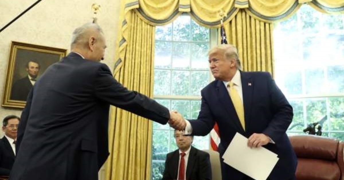 President Donald Trump shakes hands with Vice Premier Liu He in the Oval Office of the White House in Washington, Oct. 11, 2019. (AP Photo)