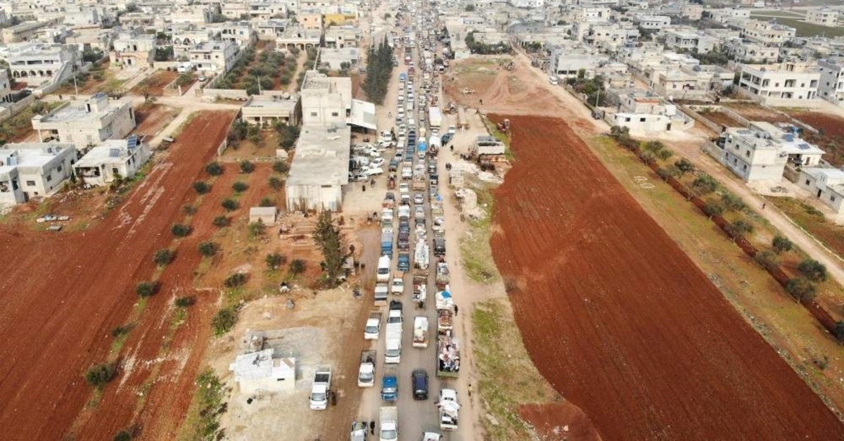 An aerial photo shows displaced Syrians driving through the northern countryside of Idlib, after fleeing its southern countryside toward areas further north near the border with Turkey, as a result of an ongoing offensive by regime forces, Jan. 28, 2020. (AFP Photo)