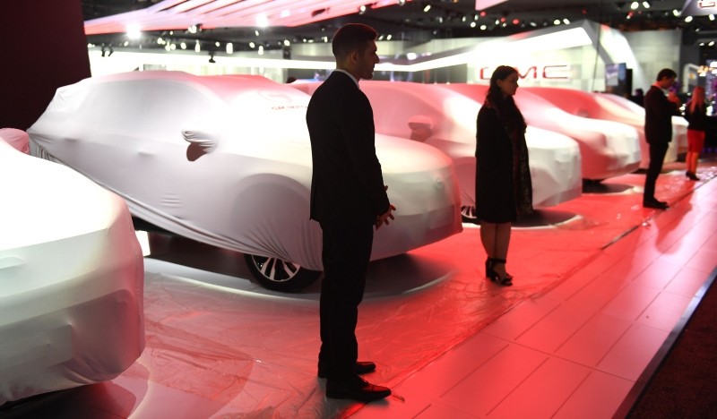 People prepare for their unvieling at GAC Motor in the Cobo Center in  Detroit Michigan January 13, 2019 (AFP Photo)