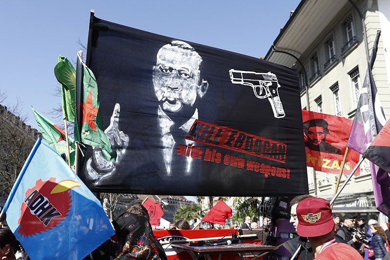 In this Saturday, March 25, 2017 photo a banner held in Swiss rally reads; 'Kill Erdou011fan with his own weapons' (AP Photo)