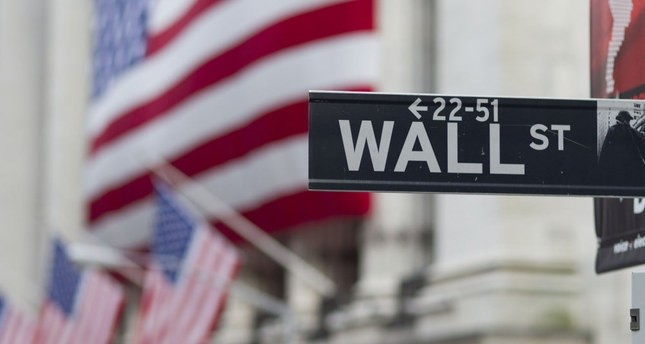 A Wall Street sign hangs near the New York Stock Exchange.