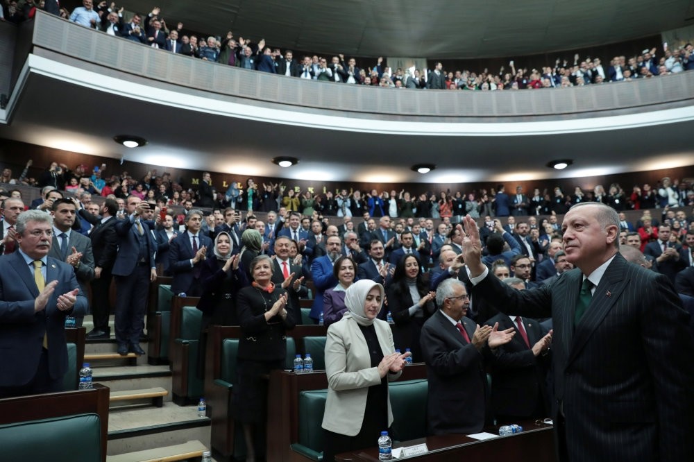 President Recep Tayyip Erdou011fan greets deputies from his ruling AK Party during a meeting in Parliament in Ankara, yesterday.